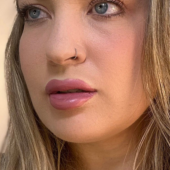Close-up of a person with blonde hair and blue eyes. lip filler. lip prosthetic