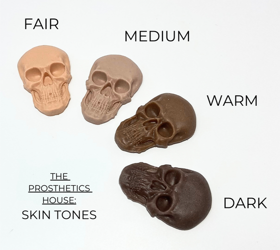 Skull-shaped prosthetics in different skin tone shades on a white background.