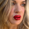 Close-up of a woman with red lipstick and blonde hair. lip filler. lip prosthetic