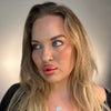 Woman with blonde hair and makeup against a neutral background plastic surgery lip filler cheek filler
